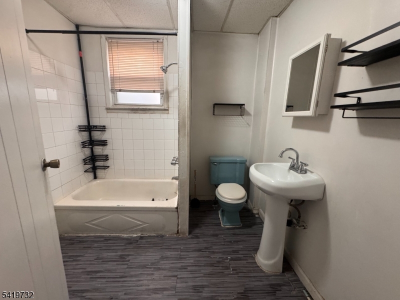 321 South 5th Street Elizabeth, NJ 07202 - Photo 4 of 10 a bathroom with a sink a toilet and shower
