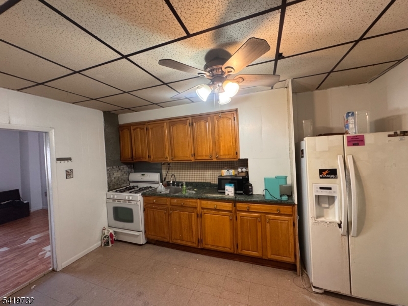 321 South 5th Street Elizabeth, NJ 07202 - Photo 5 of 10 a kitchen with stainless steel appliances a refrigerator a sink a stove and white cabinets