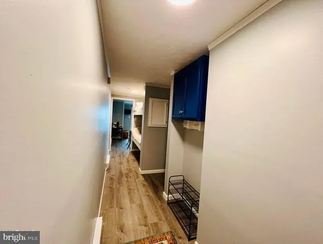 a view of hallway with wooden floor