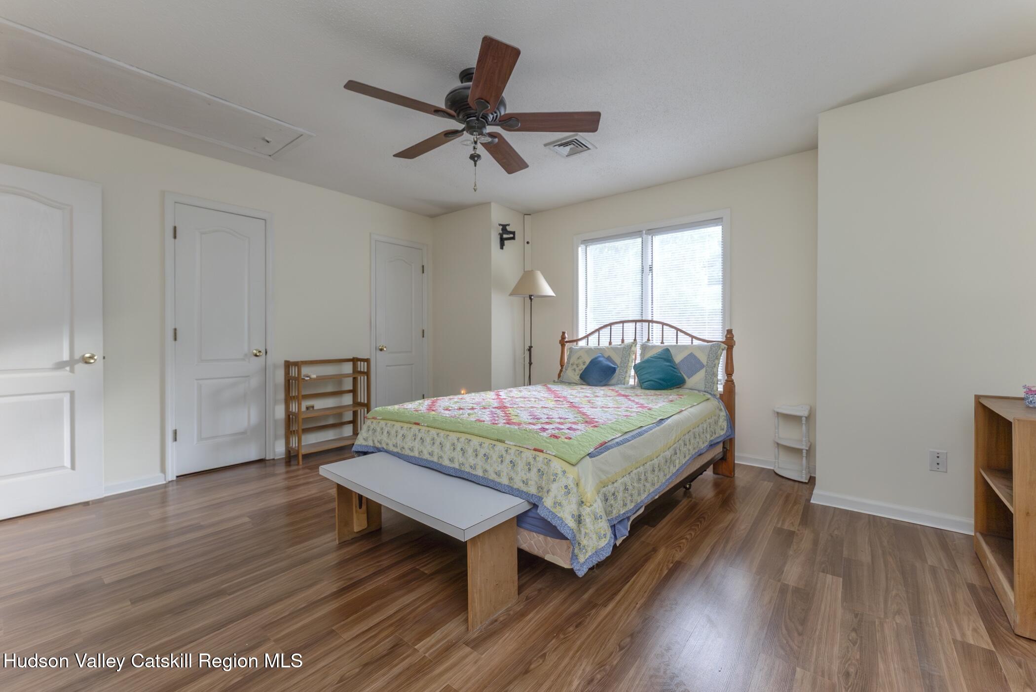 17 Riverview Port Ewen, NY 12487 - Photo 21 of 44 a bedroom with a bed a dresser and wooden floor