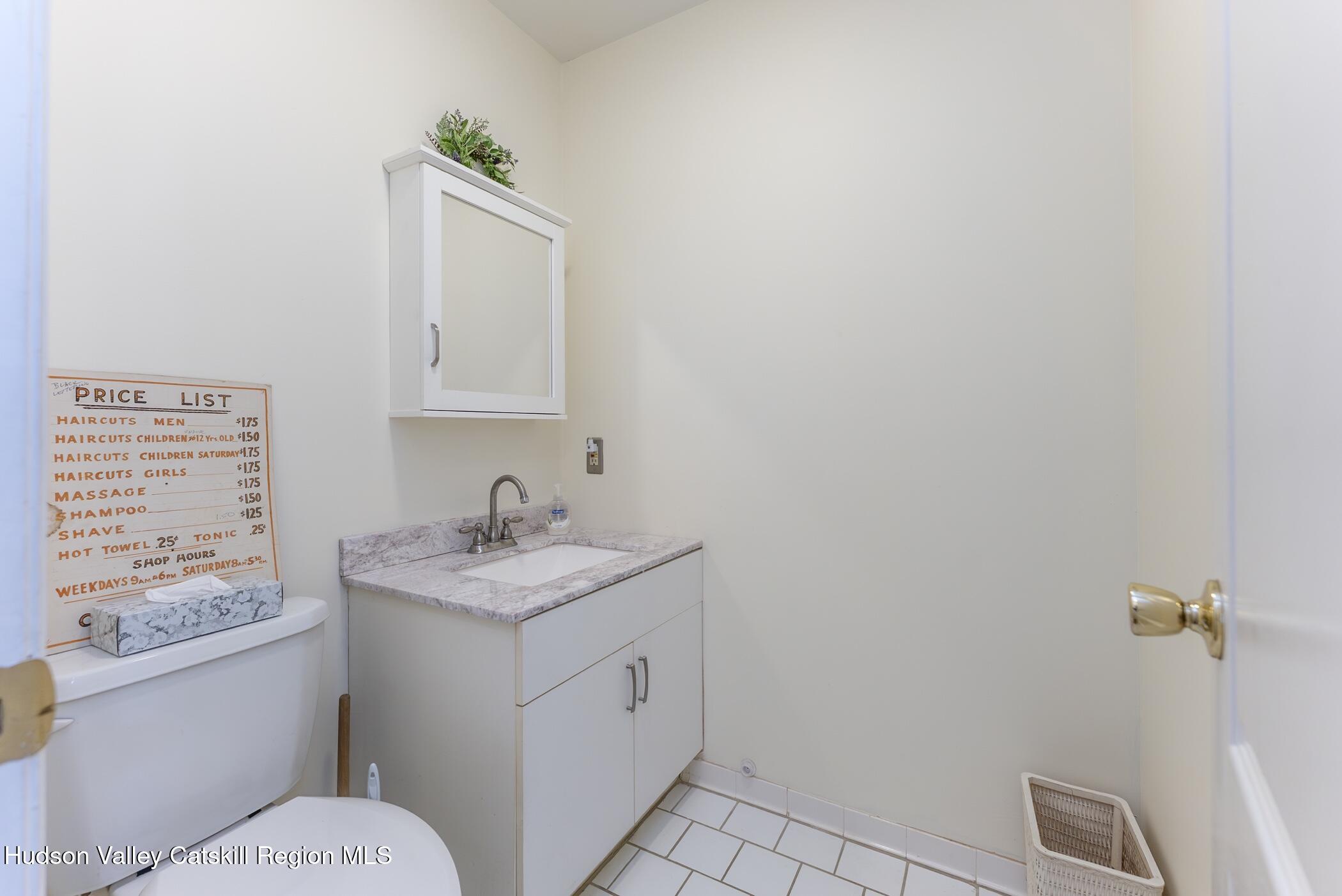 17 Riverview Port Ewen, NY 12487 - Photo 26 of 44 a bathroom with a granite countertop sink a toilet and mirror