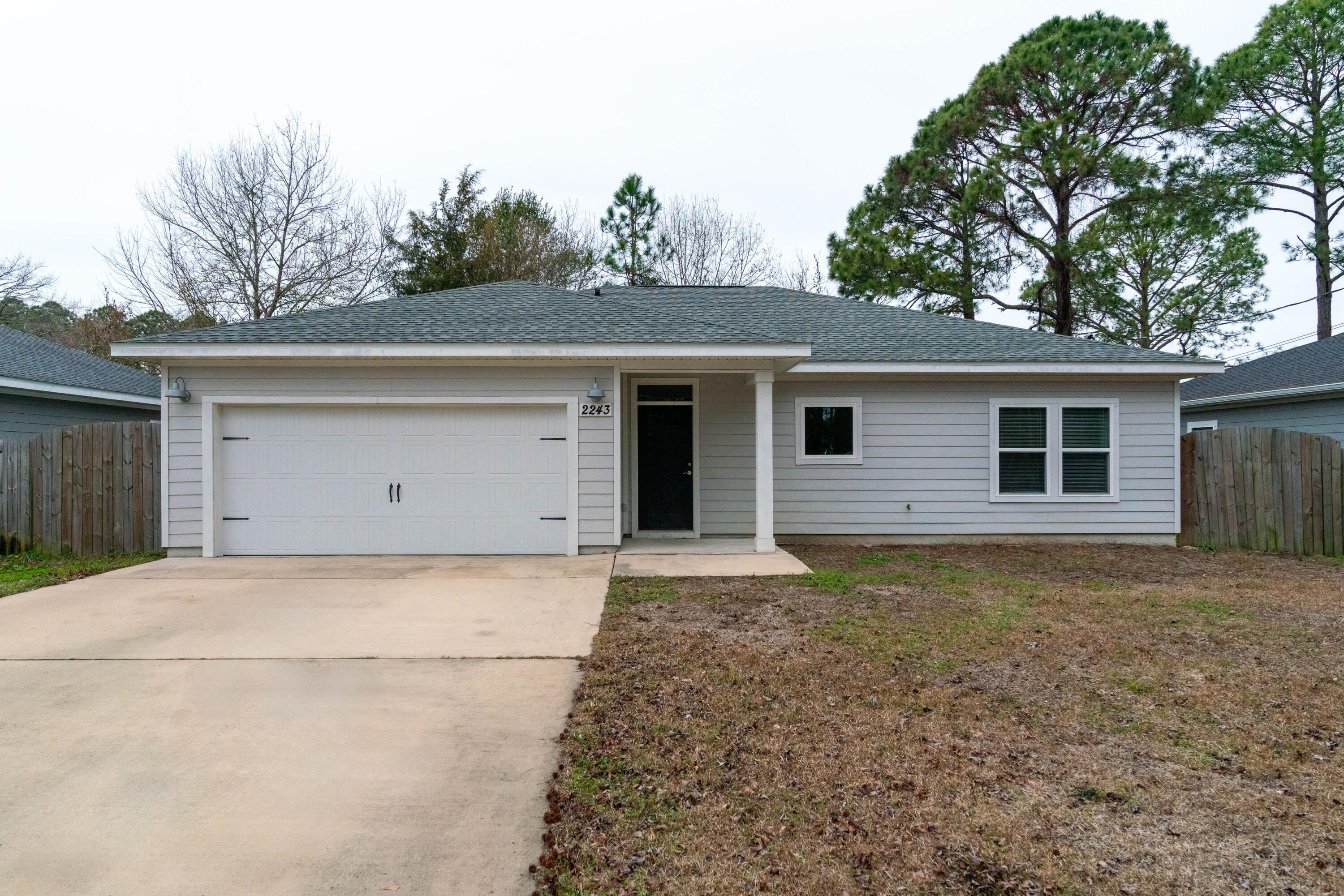 2243 Wind Trace Road North Navarre, FL 32566 - Photo 1 of 34 front view of house with a yard