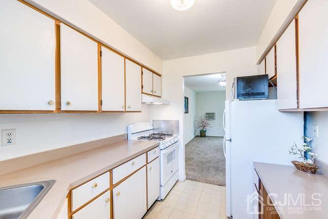 114 Redbud Road Piscataway, NJ 08854 - Photo 11 of 28 a kitchen with stainless steel appliances granite countertop a sink and cabinets
