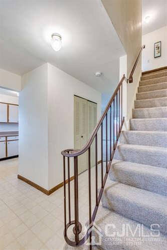 114 Redbud Road Piscataway, NJ 08854 - Photo 16 of 28 a view of staircase with lots of frames on wall and windows