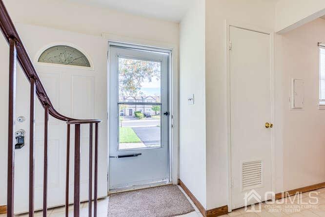 114 Redbud Road Piscataway, NJ 08854 - Photo 5 of 28 a view of entryway with stairs and a window