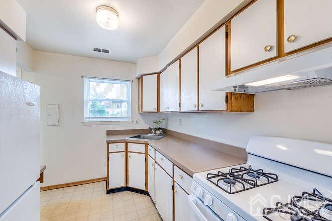 114 Redbud Road Piscataway, NJ 08854 - Photo 9 of 28 a kitchen with stainless steel appliances granite countertop a sink stove and cabinets