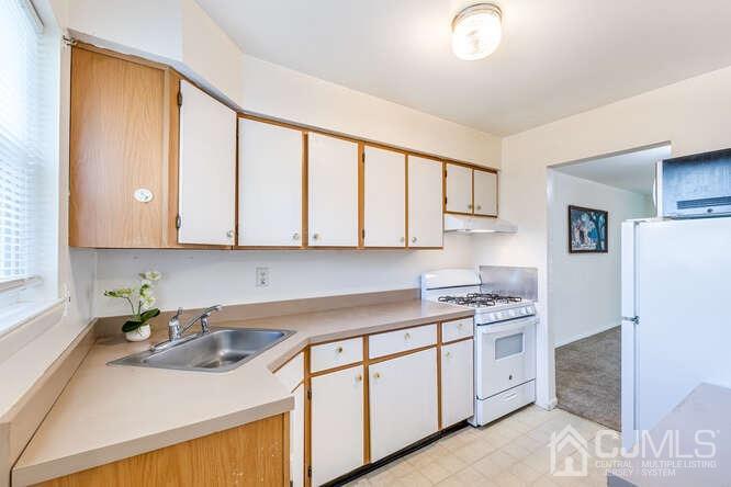 114 Redbud Road Piscataway, NJ 08854 - Photo 10 of 28 a kitchen with stainless steel appliances granite countertop a sink stove and cabinets