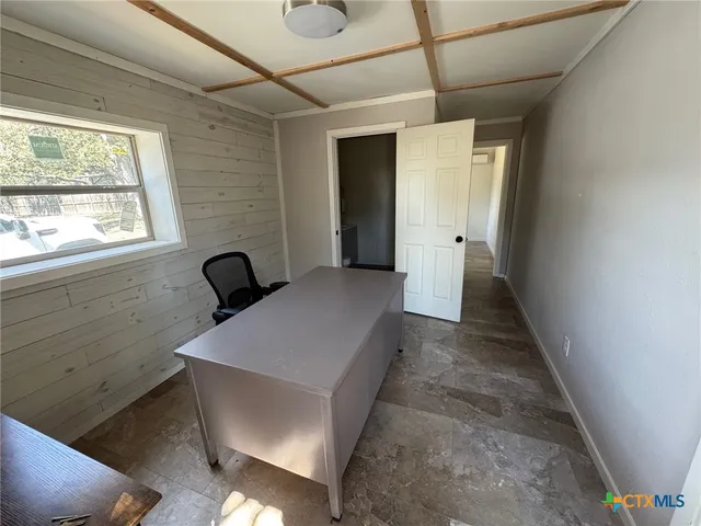 a hallway with sliding door and wooden floor