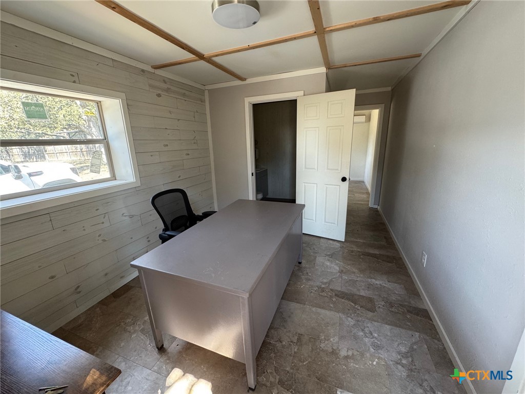2802 West 4th Street Cameron, TX 76520 - Photo 6 of 12 a hallway with sliding door and wooden floor