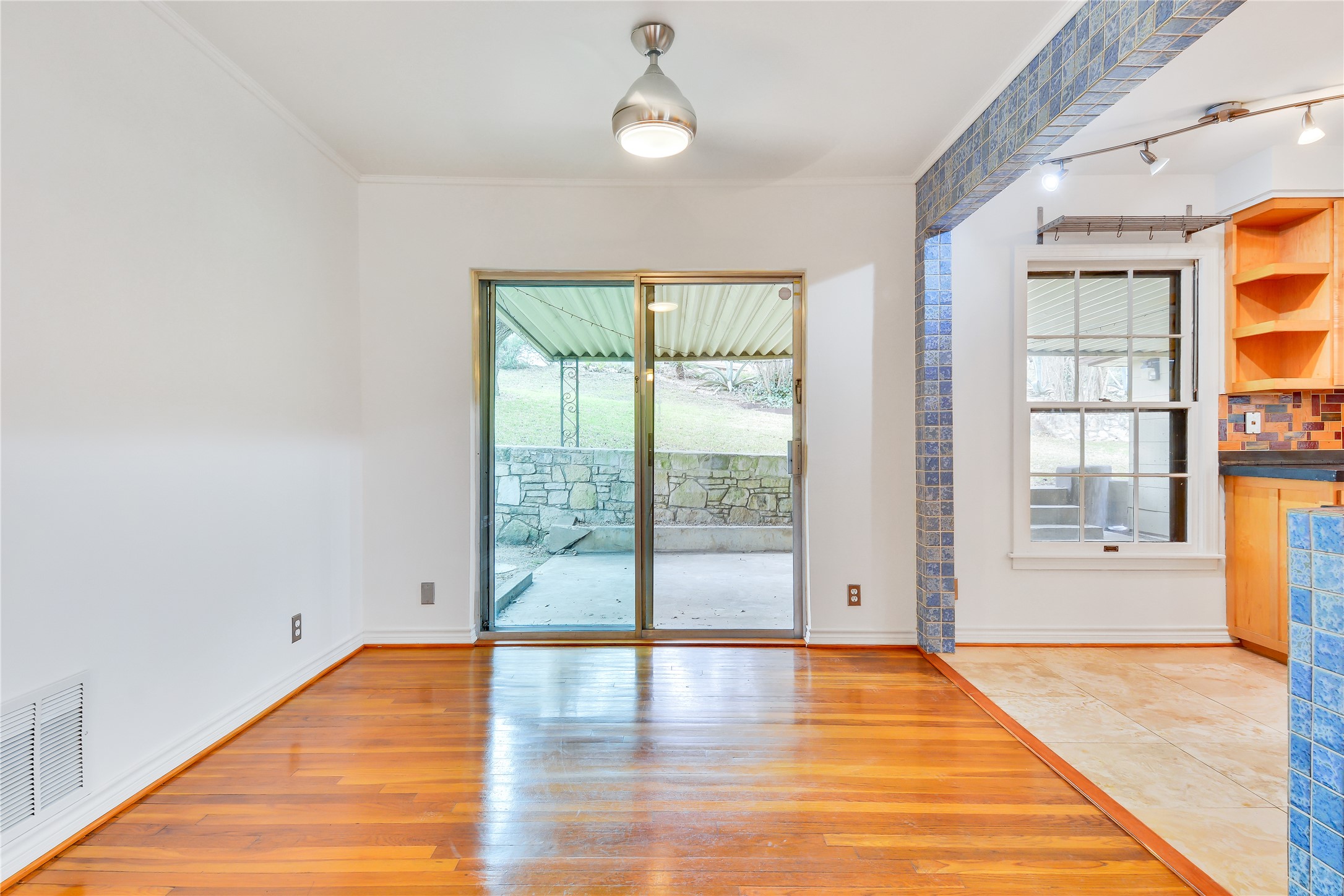 2300 Rebel Road Austin, TX 78704 - Photo 8 of 26 Hardwood flooring extends into this spacious dining area with direct access to an outdoor patio.
