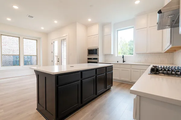 a kitchen with a sink stove and cabinets