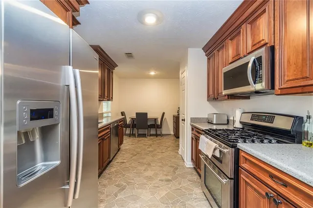 a dining room with wooden floor a chandelier a wooden table and chairs