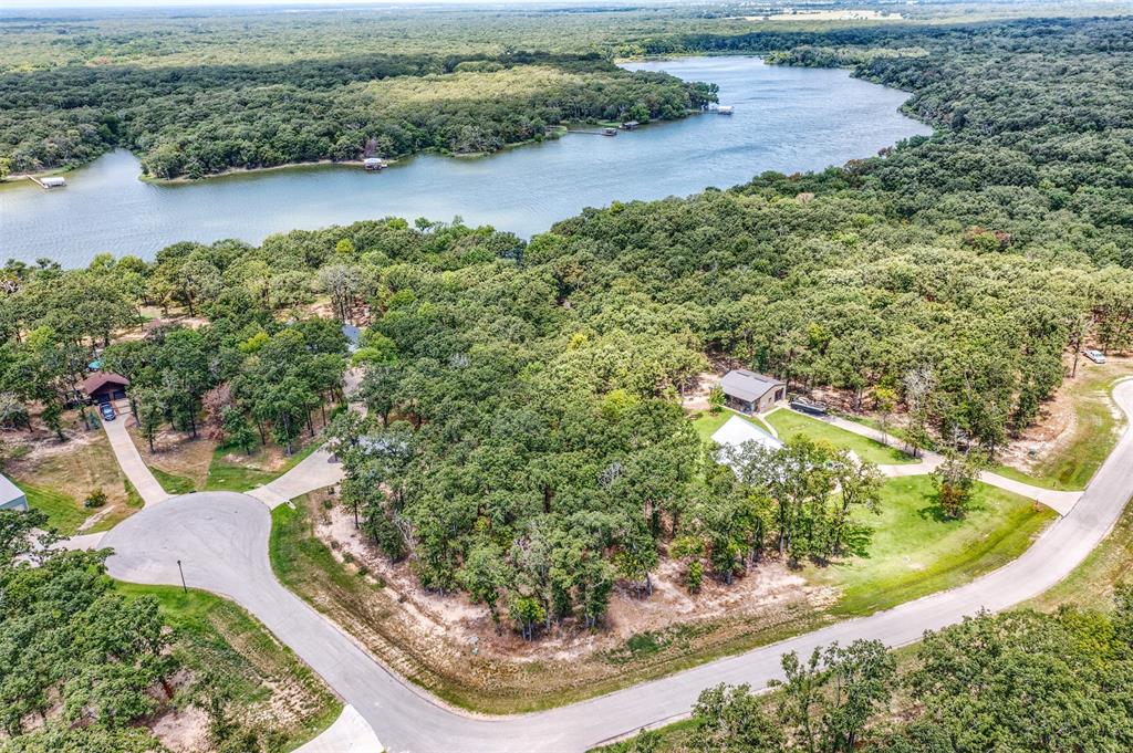 Lot 68 Anchor Point Quinlan, TX 75474 - Photo 5 of 16 Aerial view of a heavily wooded area and a nearby body of water