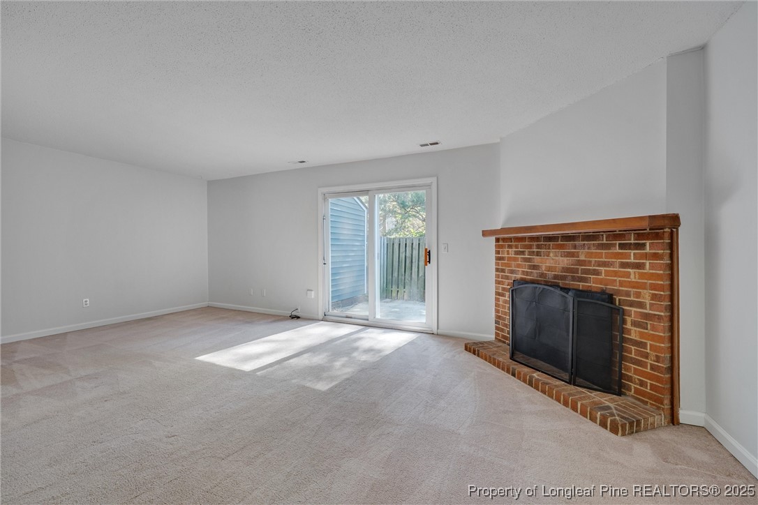 1304 Seaton Road, Unit 17 Durham, NC 27713 - Photo 14 of 32 a view of empty room with window and fireplace