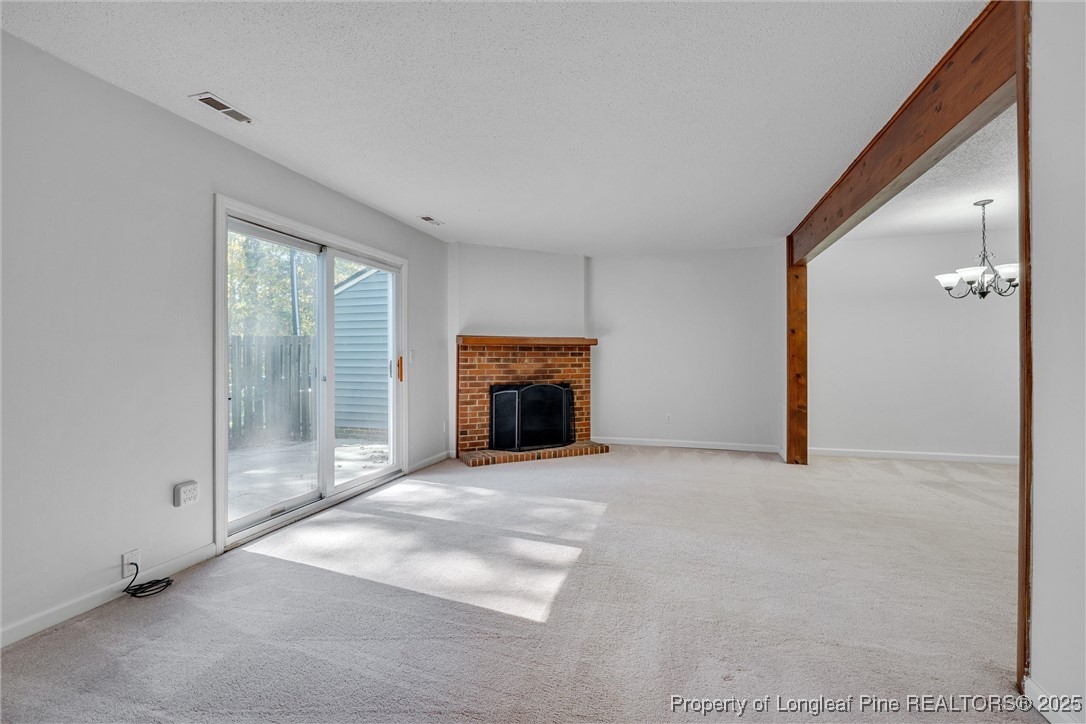1304 Seaton Road, Unit 17 Durham, NC 27713 - Photo 16 of 32 a view of an empty room with a fireplace and a window