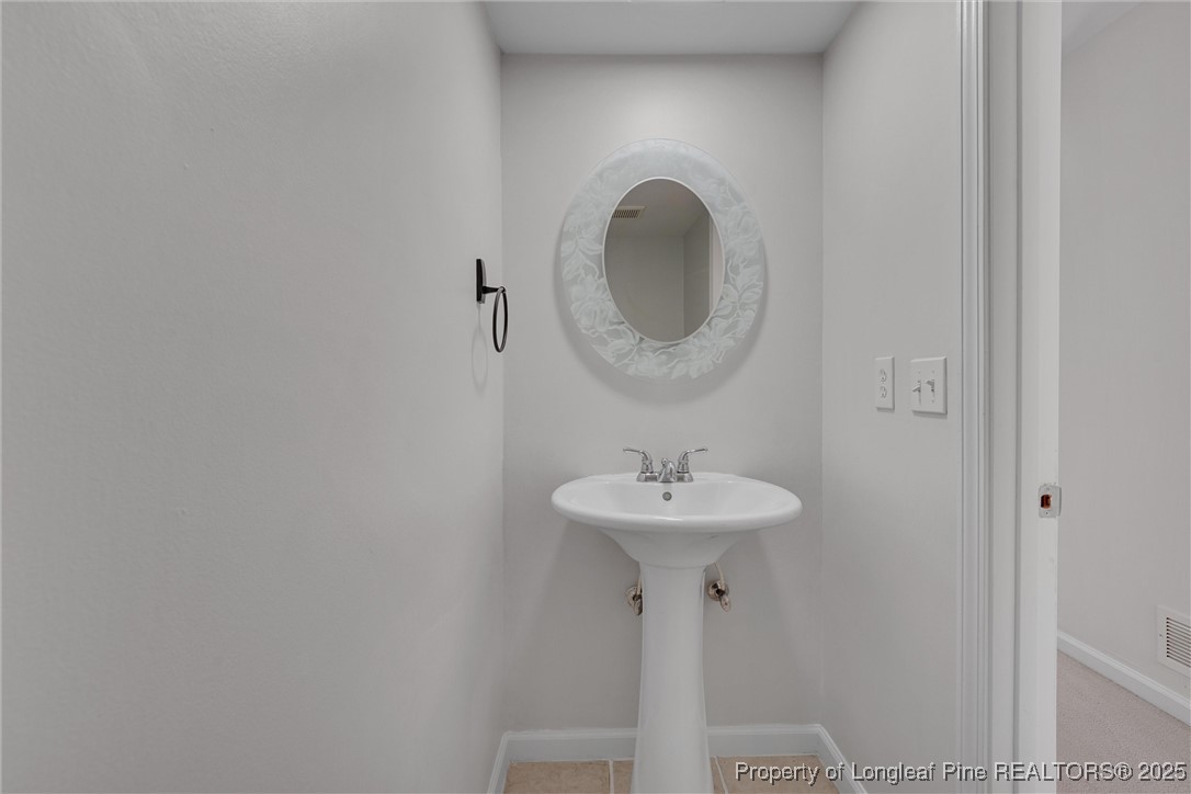 1304 Seaton Road, Unit 17 Durham, NC 27713 - Photo 19 of 32 a bathroom with a sink and mirror