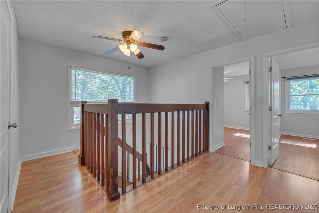 1304 Seaton Road, Unit 17 Durham, NC 27713 - Photo 21 of 32 a view of a hallway with wooden floor and chandelier