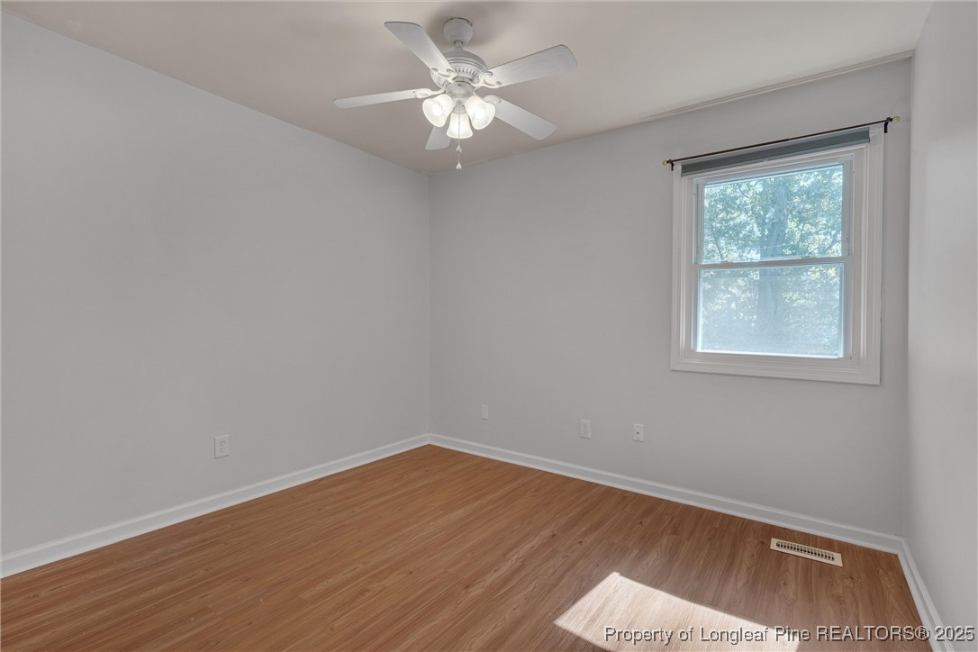 1304 Seaton Road, Unit 17 Durham, NC 27713 - Photo 25 of 32 wooden floor in an empty room with a window