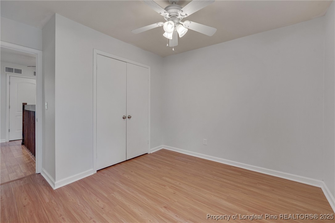 1304 Seaton Road, Unit 17 Durham, NC 27713 - Photo 26 of 32 a view of a room with wooden floor and a ceiling fan