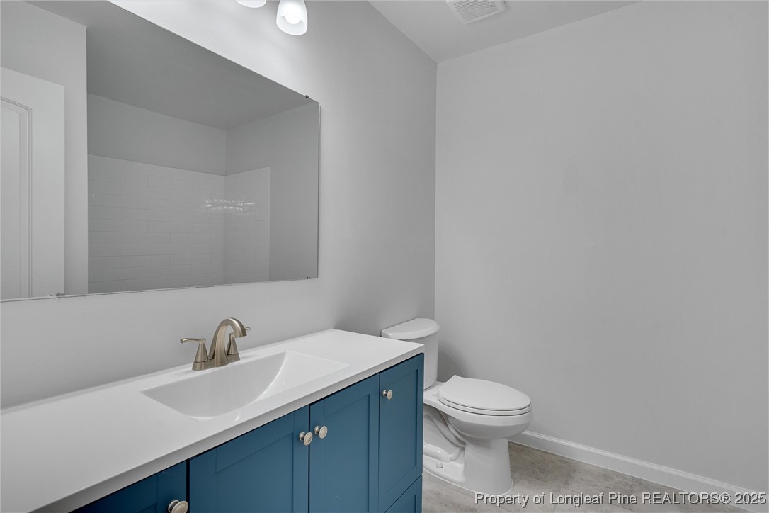 1304 Seaton Road, Unit 17 Durham, NC 27713 - Photo 27 of 32 a bathroom with a toilet a sink and mirror