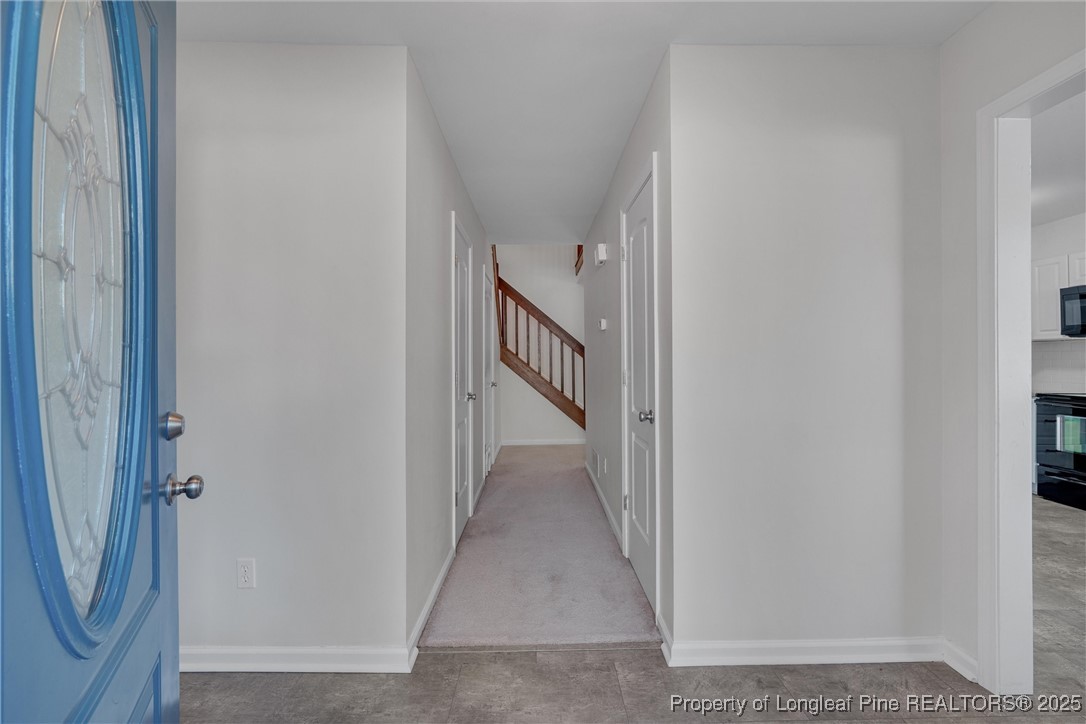 1304 Seaton Road, Unit 17 Durham, NC 27713 - Photo 3 of 32 a view of a hallway with wooden floor and staircase