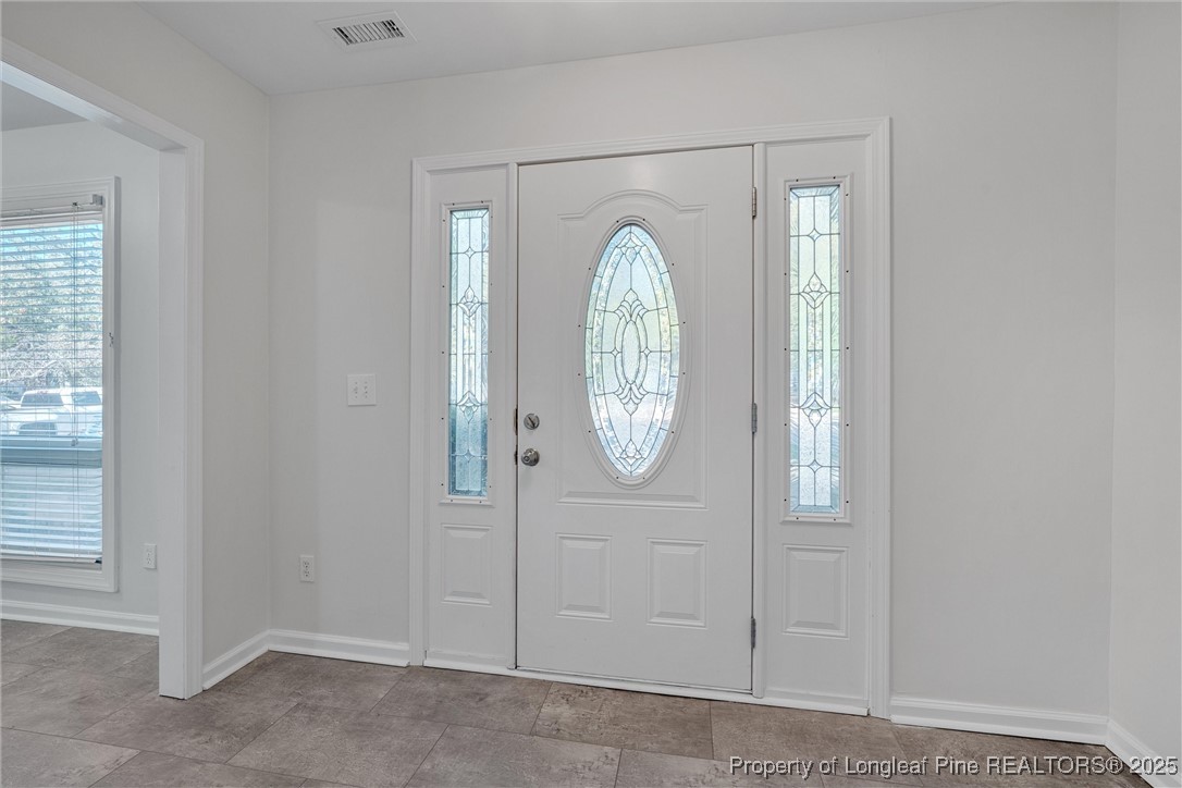 1304 Seaton Road, Unit 17 Durham, NC 27713 - Photo 4 of 32 an empty room with window mirror