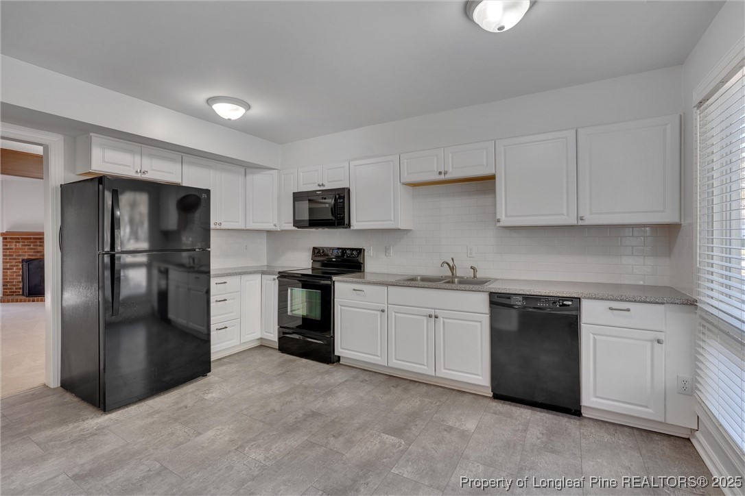 1304 Seaton Road, Unit 17 Durham, NC 27713 - Photo 5 of 32 a kitchen with a refrigerator stove and sink