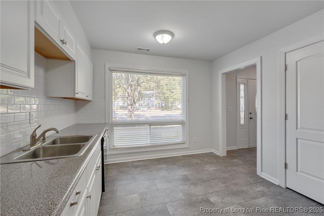 1304 Seaton Road, Unit 17 Durham, NC 27713 - Photo 7 of 32 a kitchen that has a sink window and cabinets