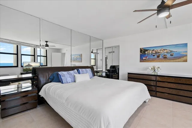 a bed room with a bed and a painting on the wall