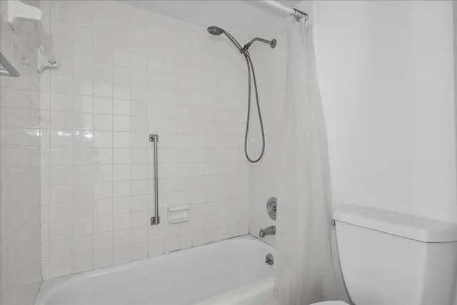 a bathroom with a bath tub with a shower