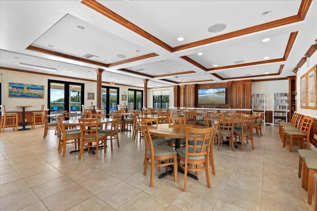 a living room with furniture and a kitchen appliance