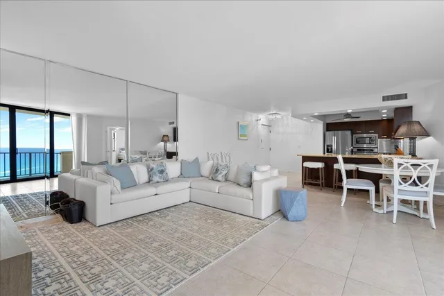 a living room with furniture and a book shelf