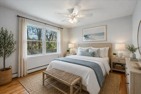 a bedroom with a large bed and a window