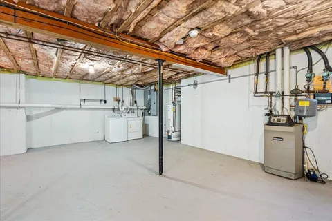 a view of a storage & utility room with refrigerator