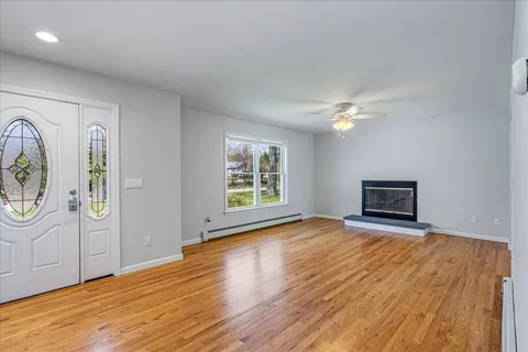 a view of livingroom with window wooden floor and fireplace