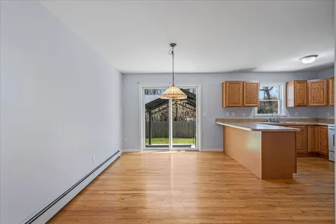a kitchen with stainless steel appliances granite countertop a stove a sink and a wooden floors