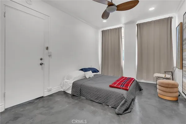 a bedroom with a bed and ceiling fan
