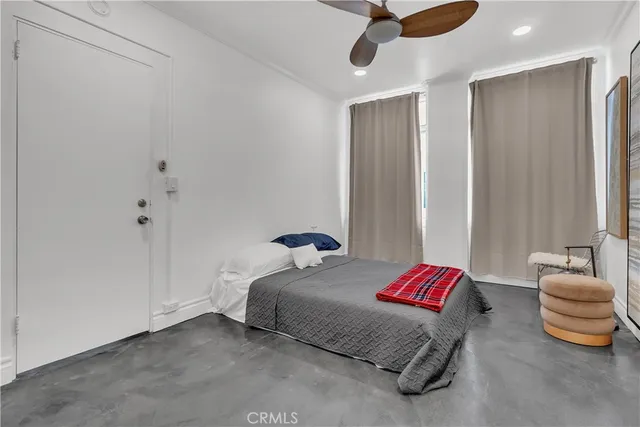 a bedroom with a bed and ceiling fan