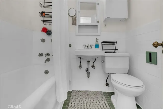 a bathroom with a toilet a sink and bathtub