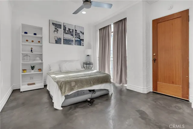 a spacious bedroom with a bed and a cabinets