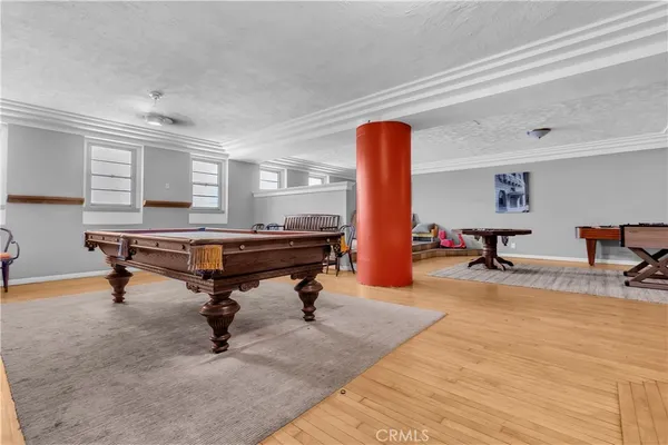 a room with furniture pool table and windows