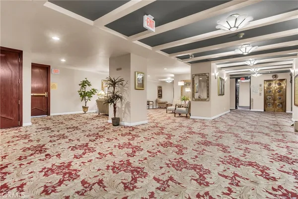 a view of a hallway to a livingroom and a kitchen