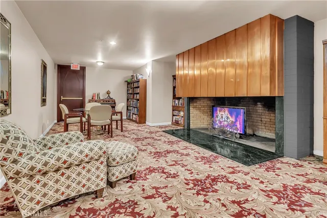 a living room with a fireplace furniture and a flat screen tv