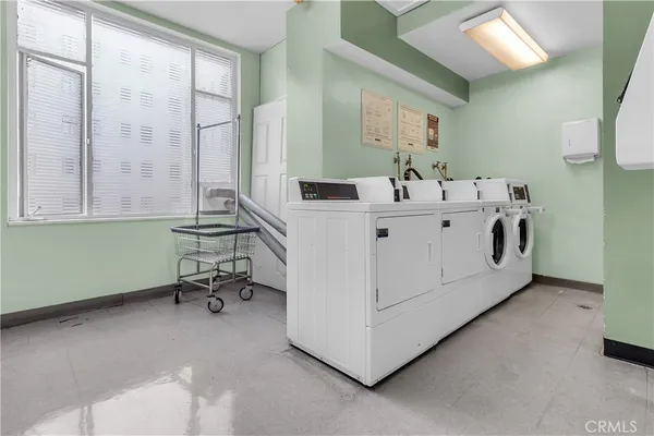 a utility room with two washing machine