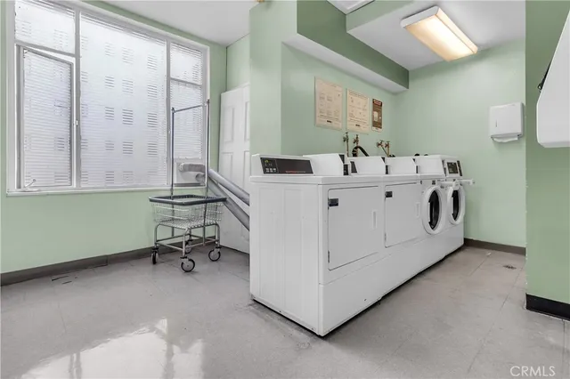 a utility room with two washing machine