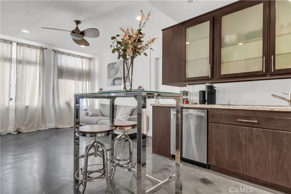 a kitchen with a table chairs sink and cabinets