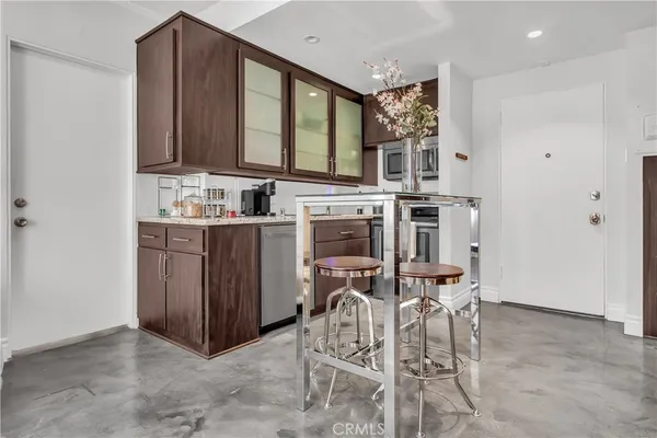 a view of a kitchen with a table and chairs