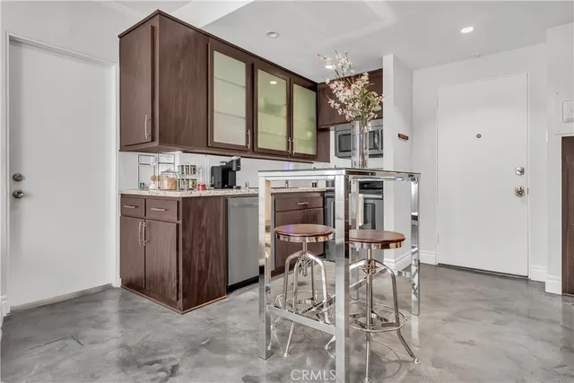 a view of a kitchen with a table and chairs