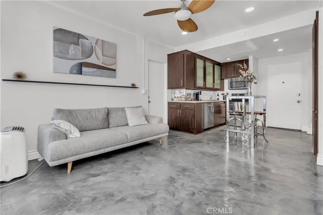 a living room with furniture and a kitchen