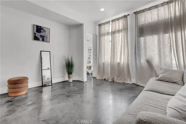 a view of a livingroom with furniture and floor to ceiling window